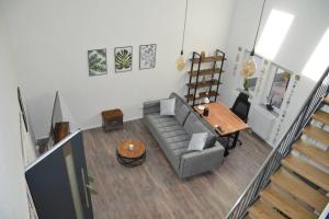 a living room with a couch and a table at Ganze Wohnung - schönes und helles Loft in Kreuzau in Kreuzau