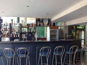 a bar with blue stools in front of it at Hotel Arda in Sunny Beach