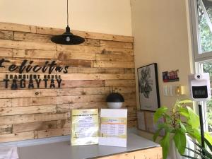 a wooden wall with two books on a counter at Felicitas Tagaytay in Tagaytay