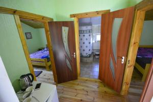 a room with two open doors and a bedroom at Садиба Лісова казка in Szack +141 photos