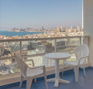 a dining room with chairs, tables, and a balcony at Hotel RH Victoria & Spa in Benidorm