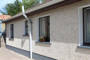 a street light on the side of a house with a window at Ketty's Cottage in Rosslea