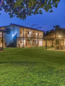 a house with a large yard at night at Pousada Trilha do Mar in Praia do Frances