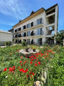 a building with red flowers in front of it at Casa Roman II by the sea in Costinesti