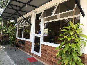 a building with windows and a chair in front of it at Felicitas Tagaytay in Tagaytay