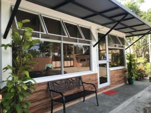 a bench in front of a building with windows at Felicitas Tagaytay in Tagaytay