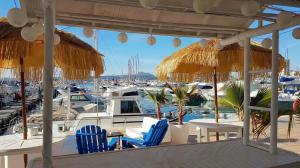 a deck with chairs and tables and boats in a marina at Very beautiful modern 2-Bed Apartment in Javea in Jávea