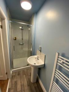 a bathroom with a sink and a shower at The Black Swan Hotel in Scarborough