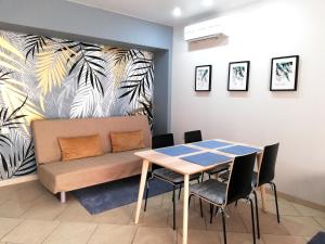 a dining room with a table and a couch at hotel OLIMP in Korenovsk