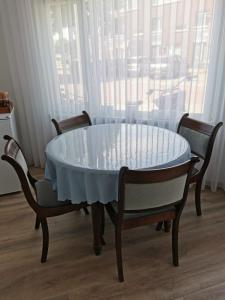 a table with two chairs and a table with a glass top at Studio Huzur in Deventer