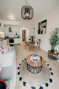 ein Wohnzimmer mit einem Sofa und einem Tisch in der Unterkunft Charmant appartement 4 étoiles Bella Vita Zen in Aix-les-Bains