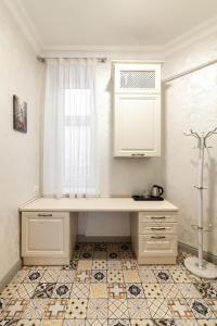 a desk in a room with a window and a tile floor at Royal mini-apart hotel on Rynok Square in Lviv