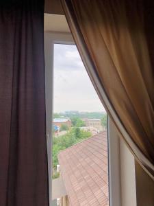 an open window with a view of a roof at Bloom Hotel in Kharkiv
