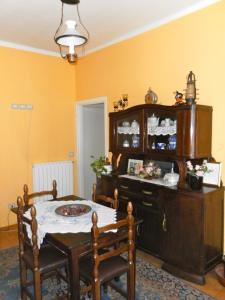 a dining room with a table and a cabinet at Cà di Twergi in Ornavasso