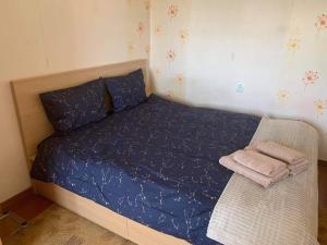 a bedroom with a bed with blue sheets and a chair at Haapsalu Sky Seat in Haapsalu +11 photos