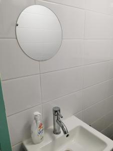 a bathroom sink with a mirror and a sink at Studio Huzur in Deventer +4 photos