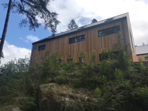 a building with windows on the side of it at An Caisteal chalet in Crianlarich
