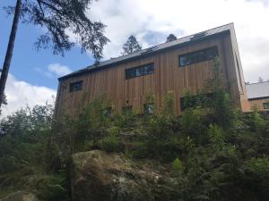 a building with windows on the side of it at An Caisteal Lodge with cascading waterfall view in Crianlarich