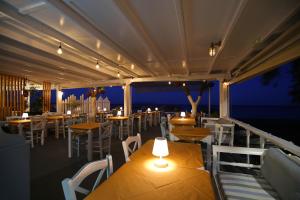 a balcony of a restaurant with tables and chairs at Seaside Breeze in Kamari