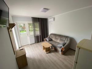 a living room with a couch and a table at Ассоль Коблеве in Koblevo