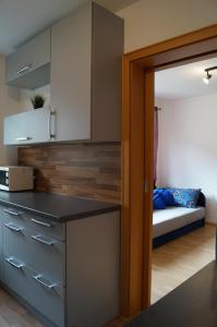 a small kitchen with a bed in a room at Ferienwohnung NEA in Dietersheim