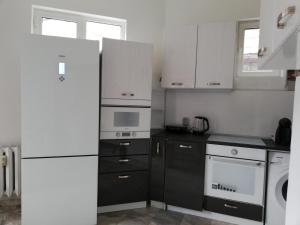 a kitchen with a white refrigerator and a dishwasher at TOP CENTER COZY AND SPACIOUS APARTMENT in Sofia