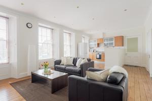 a living room with a couch and a table at The West Bow Apartment in Edinburgh
