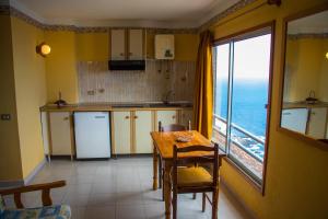 a kitchen with a table and a view of the ocean at Casa MARA Tenerife in Las Cruces