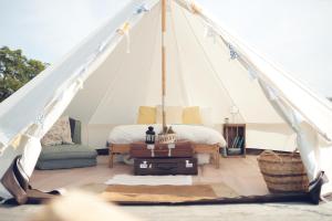 a room with a tent with a bed and luggage at Home Farm Glamping in Elstree