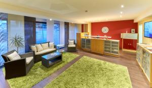 a living room with a couch and a table at Hotel Garni am Goetheplatz in Bad Münster am Stein-Ebernburg