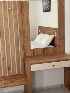 a bathroom with a wooden vanity with a mirror at Coralli Beach Hotel in Kokkini Khanion