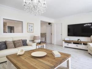 a living room with a couch and a table at Sitges Spaces Mediterranean Apartments 5 Bedrooms, 4 Bathrooms, 75M2 Terrace, Centre Sitges- Sleeps 11 in Sitges