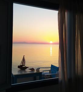 a view of a sunset from a window of a room at SEA SOUND Villa in Ágios Dimítrios