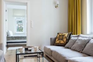 a living room with a couch and a table at Apartamenty Vincent Sopot in Sopot