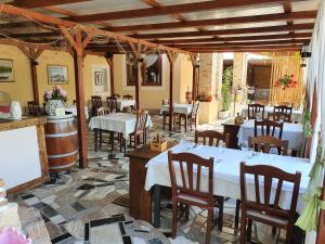 a restaurant with tables and chairs in a room at Sobe Sole in Umag
