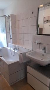 a white bathroom with a sink and a shower at Ferienwohnung Nesa in Traben-Trarbach