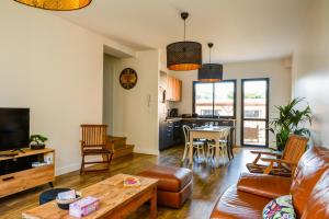a living room with a couch and a table at La Parenthèse Honfleuraise in Honfleur