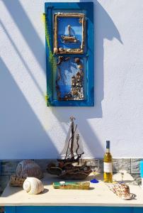 a table with a picture and a bottle of wine at SEA SOUND Villa in Ágios Dimítrios