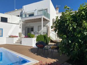 a villa with a swimming pool and a house at Casa Bravo in Querença