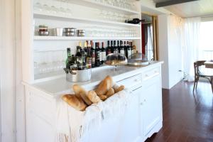 a kitchen with a counter with bread and wine bottles at Il Caminetto Montefiascone in Montefiascone +37 photos