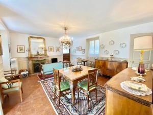 a living room with a table and a dining room at CASA L'ARBI in Pino Lago Maggiore