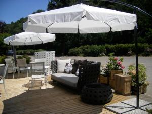 a couch sitting under an umbrella on a patio at Il Caminetto Montefiascone in Montefiascone
