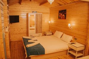 a bedroom with a bed in a wooden cabin at Pirlanta Butik Hotel in Çeşme +127 photos