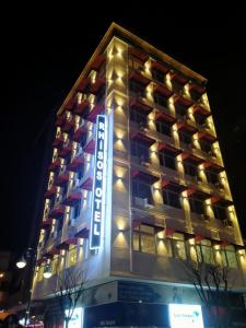 a hotel building with a sign on the side of it at Rhisos Otel in Rize