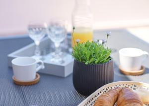 a table with a plate of bread and a vase with flowers at Family Petrov Apartments in Vodice