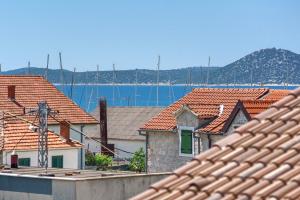 a view of roofs of houses and the water at Family Petrov Apartments in Vodice +54 photos