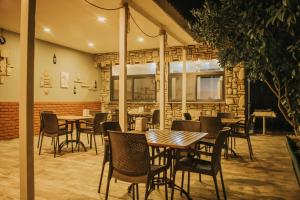 a restaurant with tables and chairs in a room at Pirlanta Butik Hotel in Çeşme