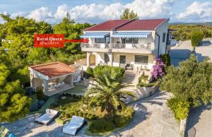 an aerial view of a house with a sign at Apartments Villa Punta Royal in Pirovac +12 photos