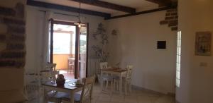 jadalnia ze stołami i krzesłami oraz oknem w obiekcie B&B VENTO DELL'EST w mieście Potenza Picena