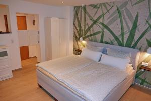 sypialnia z łóżkiem i zieloną ścianą w obiekcie Harzapart Apartment 3 "Hirsch" w mieście Walkenried